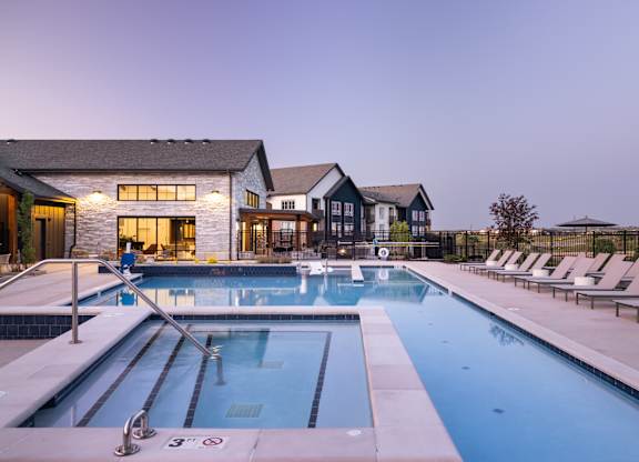 A large swimming pool with lane markers and a diving board.
