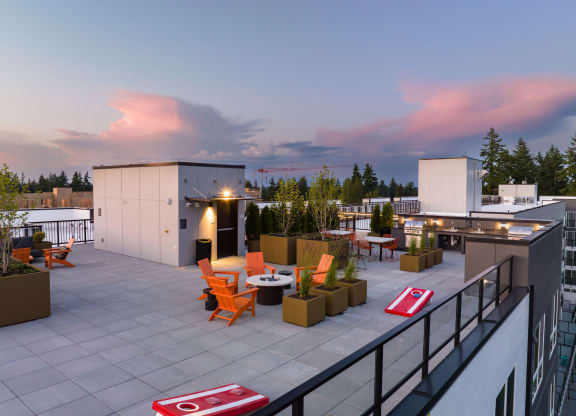 a roof top terrace with orange chairs and potted plants at Ion Town Center, Shoreline, WA