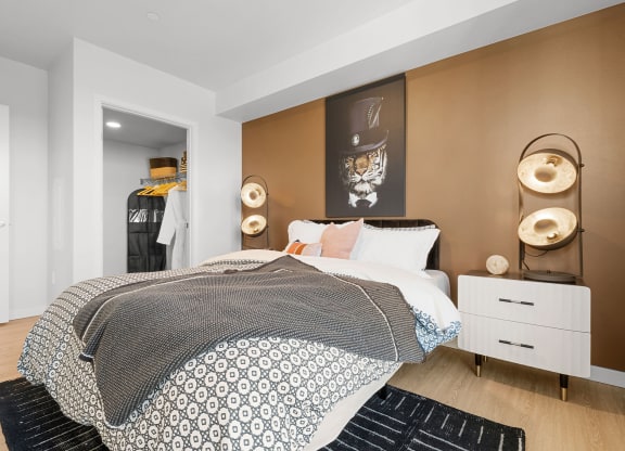 a bedroom with a bed and a dresser in front of it at Ion Town Center, Washington, 98133