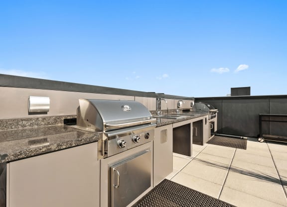 a kitchen with stainless steel appliances and granite counter tops at Ion Town Center, Shoreline, WA