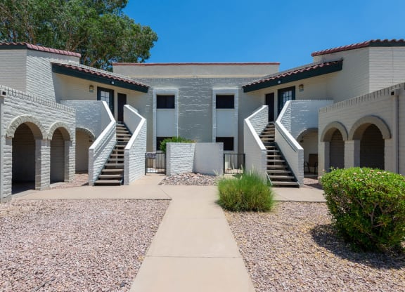 Residential building with a lawn and landscaping in front of it