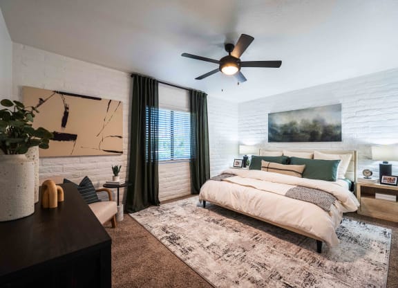 a bedroom with a bed and a ceiling fan