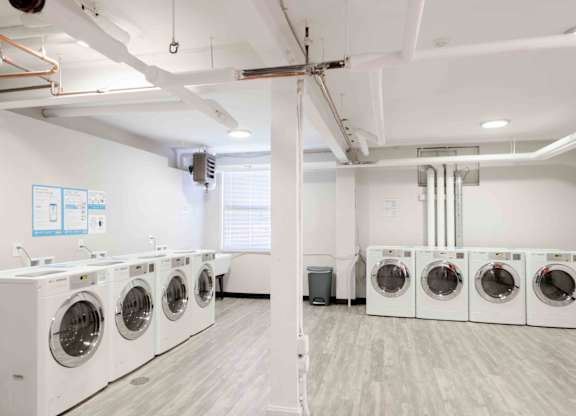 A row of washing machines in a laundry room.