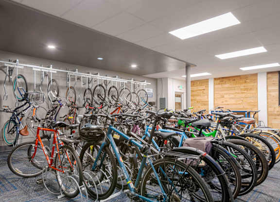 A bike rack full of bicycles in a room.