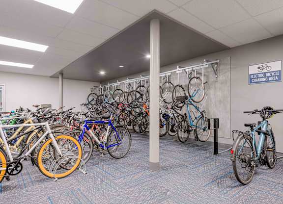 A room full of bicycles is an electric bicycle charging area.