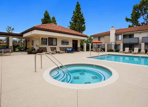 A swimming pool in a backyard with a house in the background.