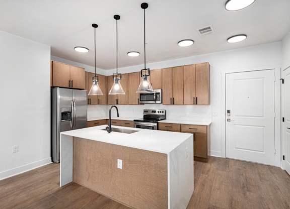 A kitchen with wooden cabinets and a white countertop.