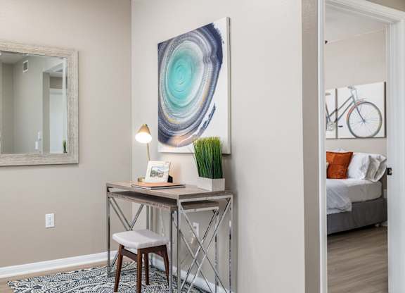A room with a desk, chair, and a painting on the wall at Clear Creek Meadows Apartments, Copperas Cove, Texas