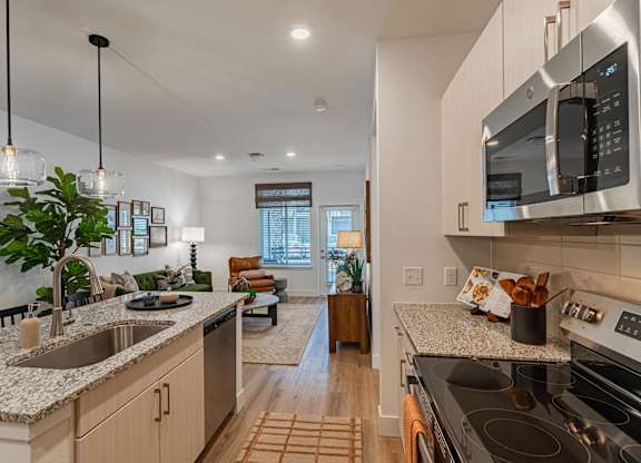 A modern kitchen with a stainless steel oven and microwave.
