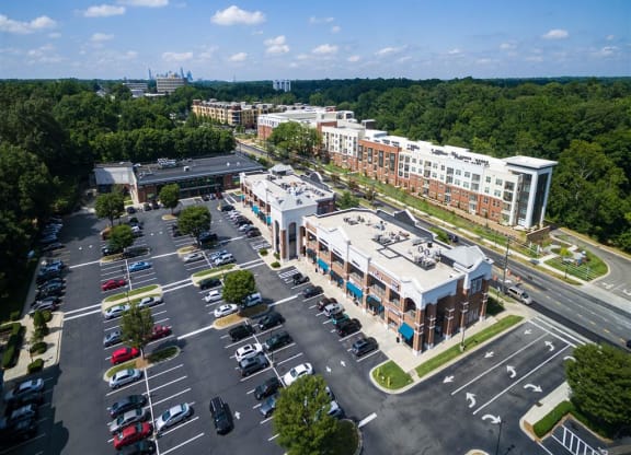 an aerial view of a parking lot and buildings