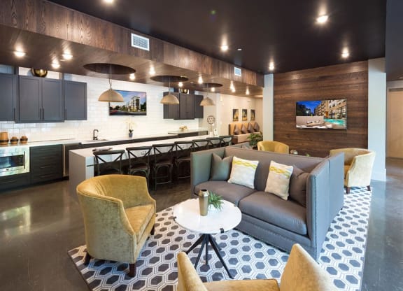a living room and kitchen with a couch and a table