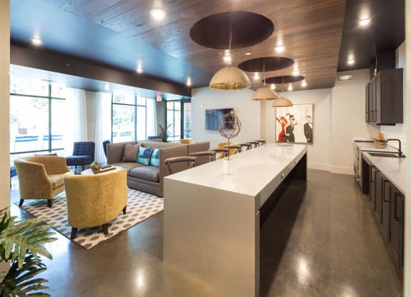 a large living room with a kitchen and a table