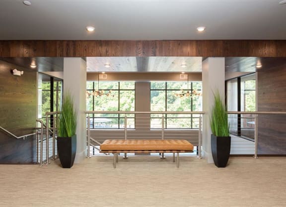 a large lobby with a bench and a large window