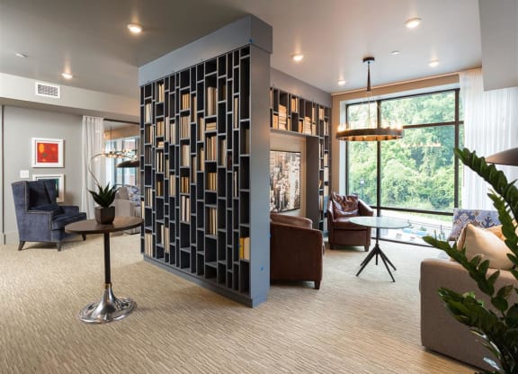 a living room filled with furniture and a large screen