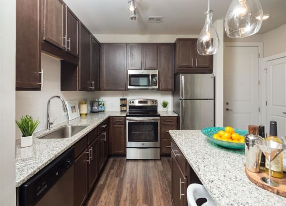 a kitchen with stainless steel appliances and granite counter tops