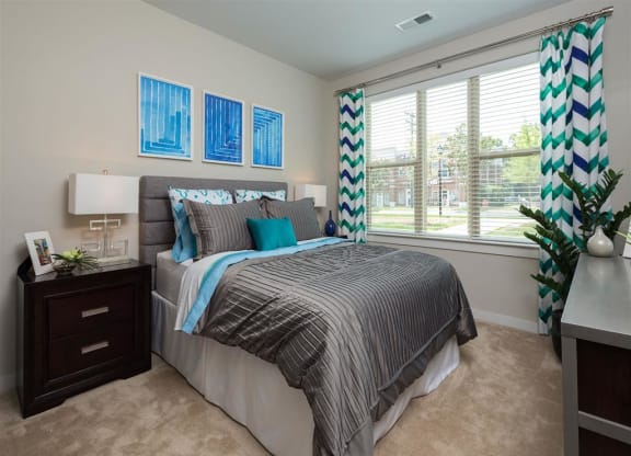 a bedroom with a large window and a bed