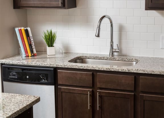 a kitchen counter with a sink and a faucet