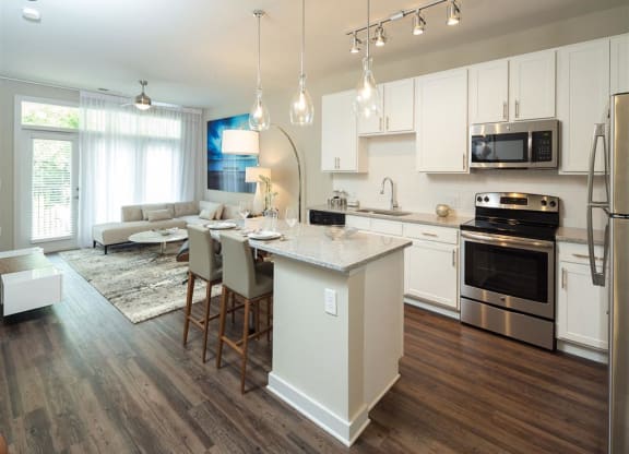 a kitchen and living room with an island in the middle