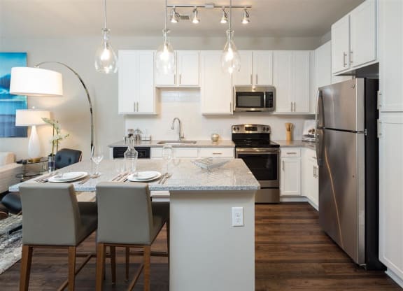 a kitchen and dining room with stainless steel appliances