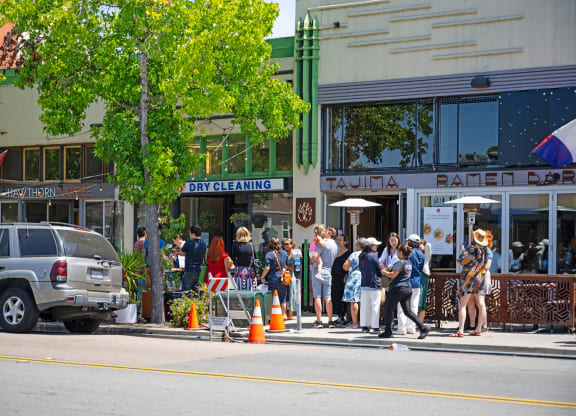 a crowd of people are standing on a city street