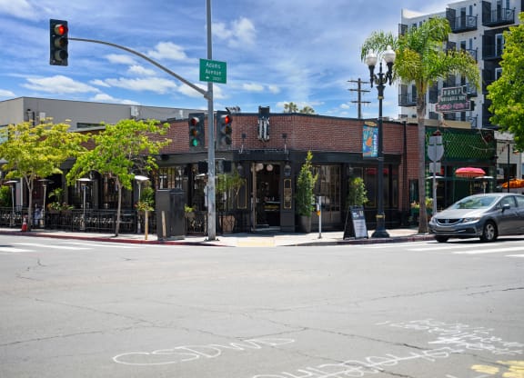 a city street with a red brick building and a traffic light