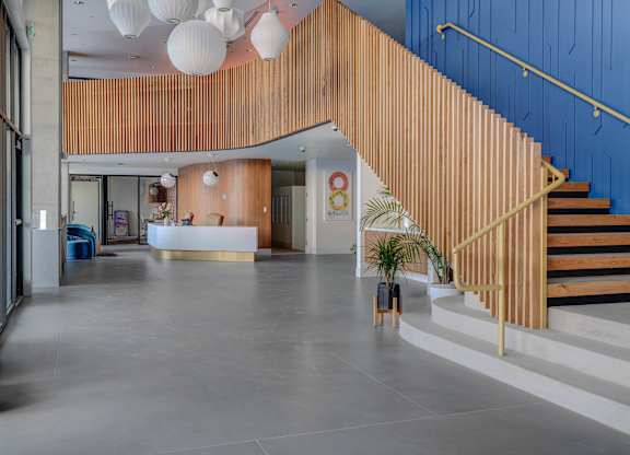 A wooden staircase with a blue wall on the side.
