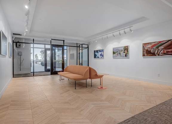 A room with a wooden floor and a brown chair.