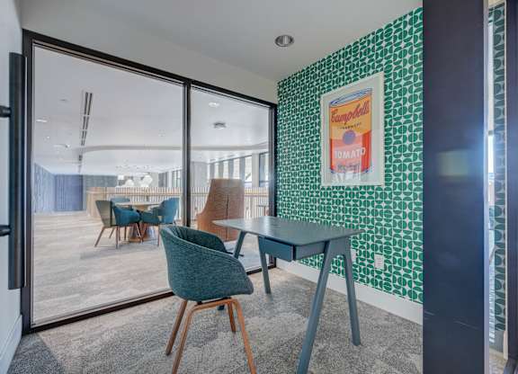 A room with a green chair and a green table.