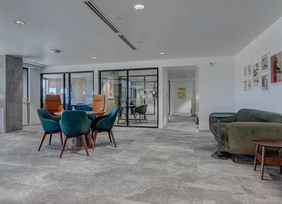 A living room with a grey carpet and a green sofa.