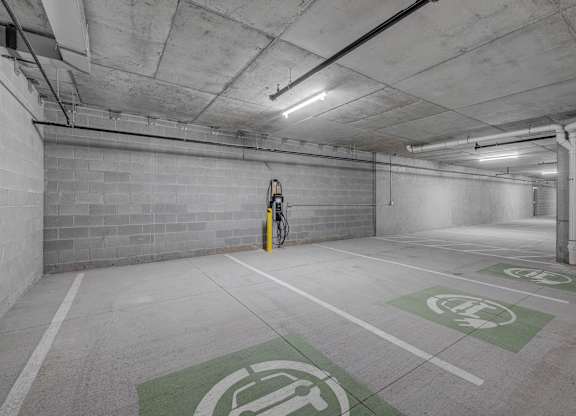 A parking garage with a bicycle parked in the corner.