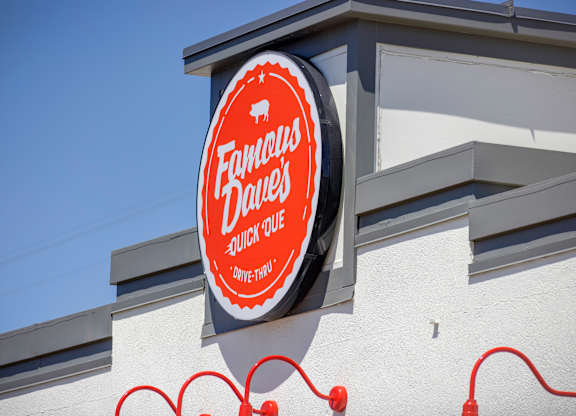 A sign for Fandango Drive-In sits on a building.