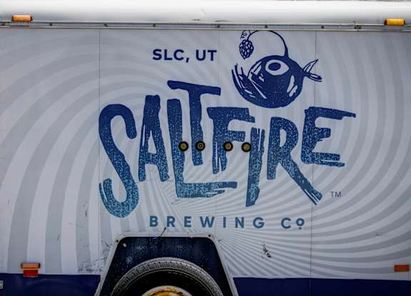 A truck with a blue fish and the words