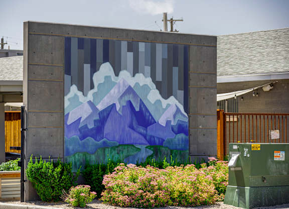 A mural of mountains painted on a wall.