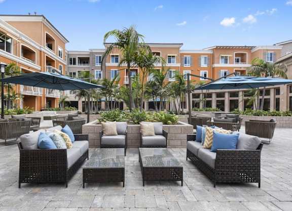 A patio with black furniture and a blue sky.