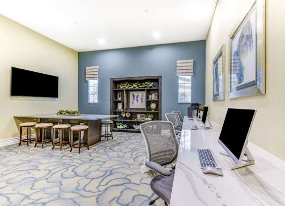 A modern office with a bar area and a television.