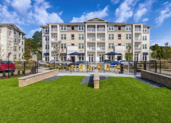 a courtyard with a fountain and an apartment building in the background