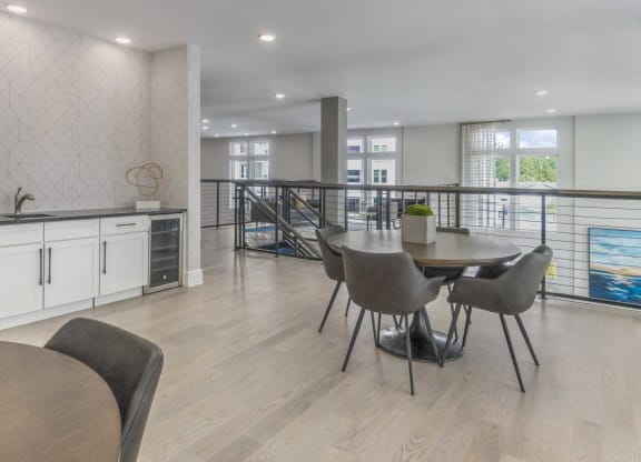 a dining room with a table and chairs and a balcony
