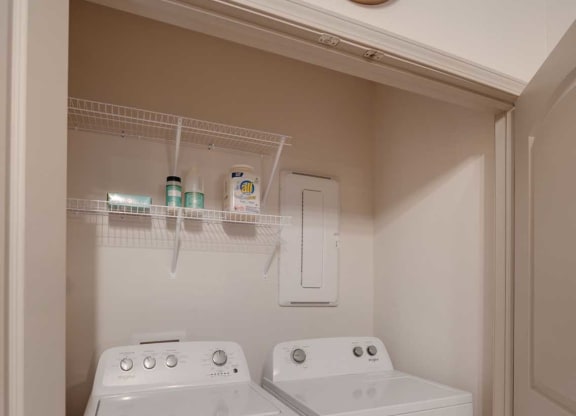 a washer and dryer in a room with a clock on the wall