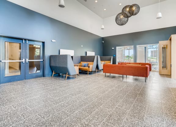 a lobby with couches and chairs and a coffee table