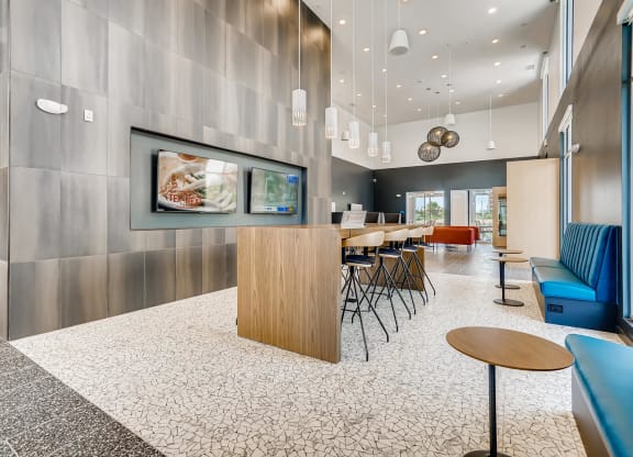a lobby with a table and chairs and a tv