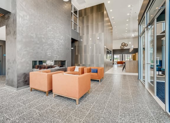 a large lobby with couches and a fireplace