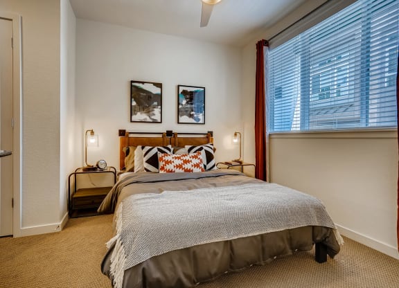 a bedroom with a bed and a large window