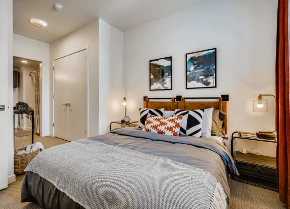 a bedroom with a bed and a door to a bathroom
