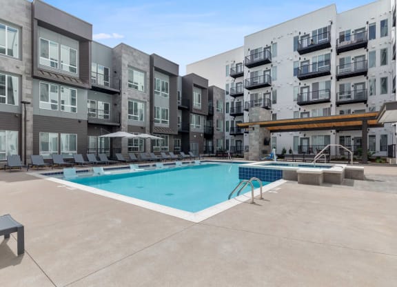 a swimming pool in front of an apartment building
