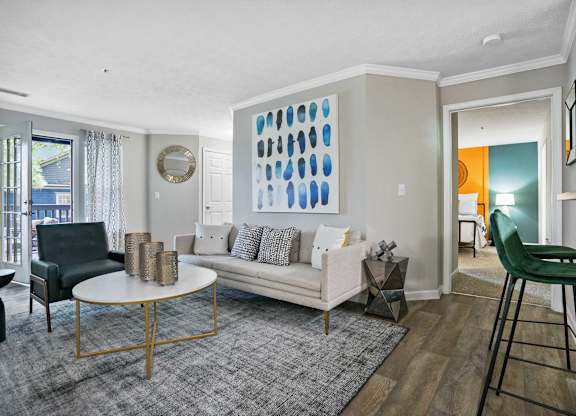 Living room with couch, chair and bar stools.