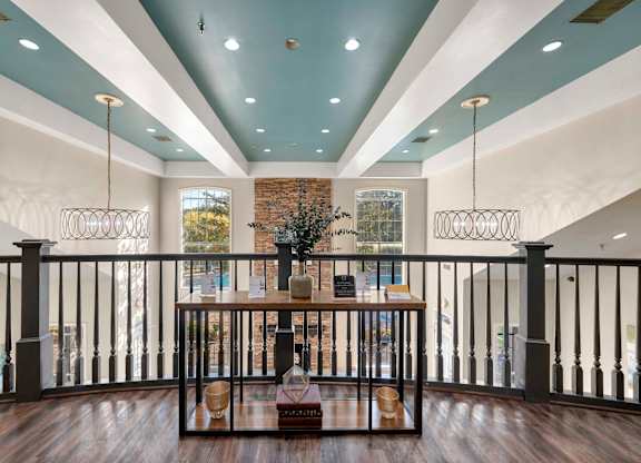 Indoor area with vaulted ceilings and balcony railing