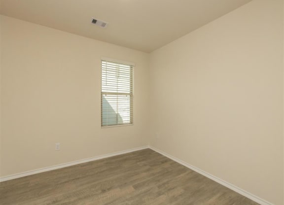 a bedroom with white walls and a window at The Village at Granger Pines, Conroe, 77302