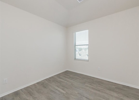 an empty room with white walls and a window at The Village at Granger Pines, Conroe, TX 77302