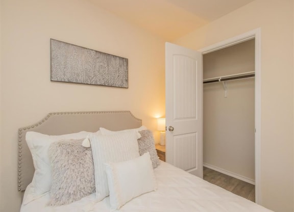 a bedroom with a bed and a closet at The Village at Granger Pines, Conroe, TX at The Village at Granger Pines, Conroe, 77302