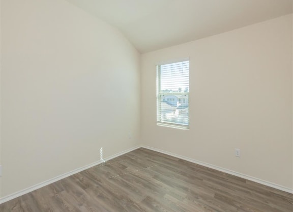 a bedroom with white walls and a window at The Village at Granger Pines, Conroe, TX
